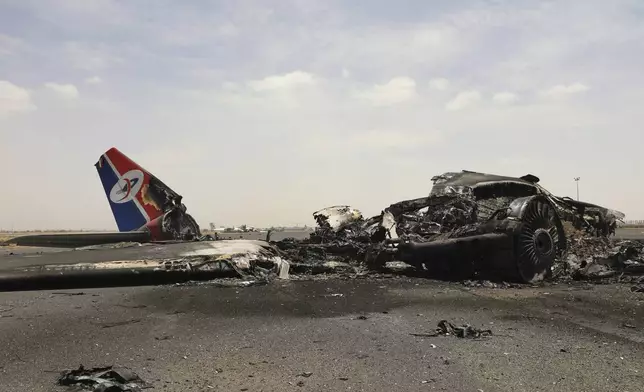 Yemenis inspect wreckage of a destroyed civilian aircraft following Israeli airstrikes on Sanaa International Airport in Sanaa, Yemen, Wednesday, May 7, 2025. (AP Photo/Osamah Abdulrahman)