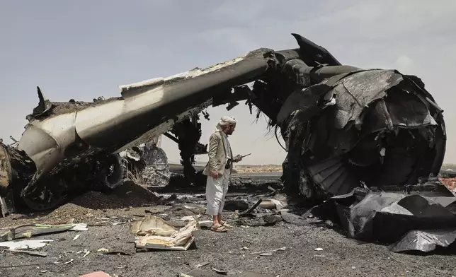 A Yemeni officer inspects the wreckage of a destroyed civilian aircraft following Israeli airstrikes on Sanaa International Airport in Sanaa, Yemen, Wednesday, May 7, 2025. (AP Photo/Osamah Abdulrahman)