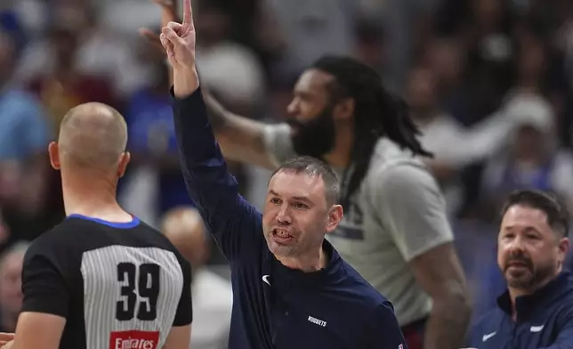 Denver Nuggets interim head coach David Adelman, center, argues for a call with referee Tyler Ford, left, as Nuggets trainer Dan Shimensky, right, comes over to stop him in the first half of Game 4 in the Western Conference semifinals of the NBA basketball playoffs against the Oklahoma City Thunder, Sunday, May 11, 2025, in Denver. (AP Photo/David Zalubowski)
