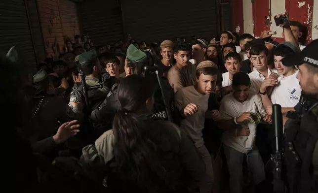 Israeli police scuffle with young Israelis marching through Jerusalem's Old City marking Jerusalem Day, an Israeli holiday celebrating the capture of east Jerusalem in the 1967 Middle East War, Monday, May 26, 2025. (Photo: AP/Leo Correa)