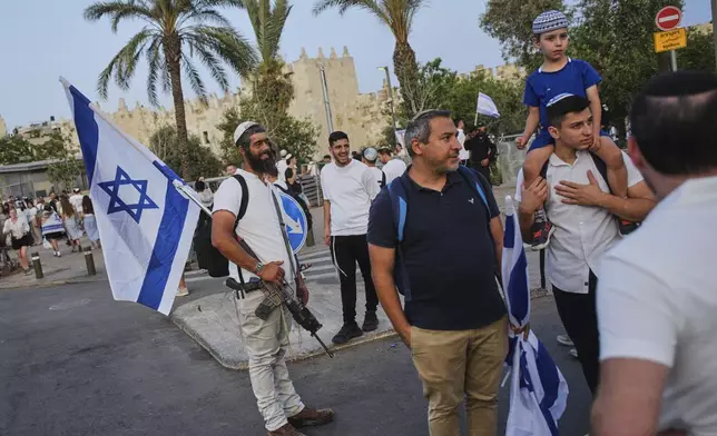 Israelis participate in a march marking Jerusalem Day, an Israeli holiday celebrating the capture of east Jerusalem in the 1967 Mideast war, in Jerusalem, Monday, May 26, 2025. (AP Photo/Ohad Zwigenberg)