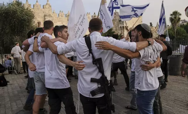Israelis participate in a march marking Jerusalem Day, an Israeli holiday celebrating the capture of east Jerusalem in the 1967 Mideast war, in Damascus Gate of Jerusalem's Old City, Monday, May 26, 2025. (AP Photo/Leo Correa)