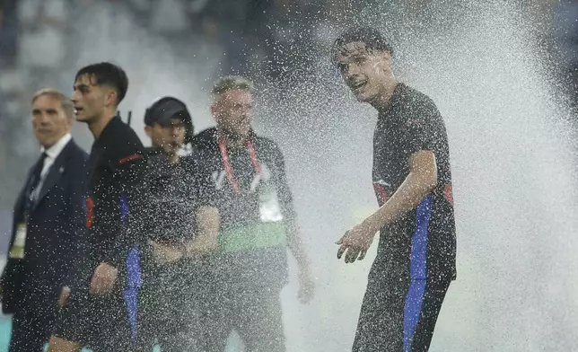 Barcelona's Hector Fort celebrates at the end of the Spanish La Liga soccer match between Barcelona and Espanyol at Lluis Companys Olympic Stadium in Barcelona, Spain, Thursday, May 15, 2025. (AP Photo/Joan Monfort)