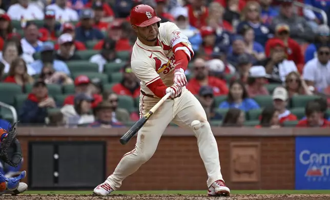 St. Louis Cardinals' Willson Contreras hits a two-run single in the fourth inning during the first baseball game of a doubleheader against the New York Mets, Sunday, May 4, 2025, in St. Louis. (AP Photo/Joe Puetz)