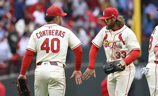 St. Louis Cardinals first baseman Willson Contreras (40) celebrates with left fielder Brendan Donovan (33) after defeating the New York Mets in the first baseball game of a doubleheader, Sunday, May 4, 2025, in St. Louis. (AP Photo/Joe Puetz)