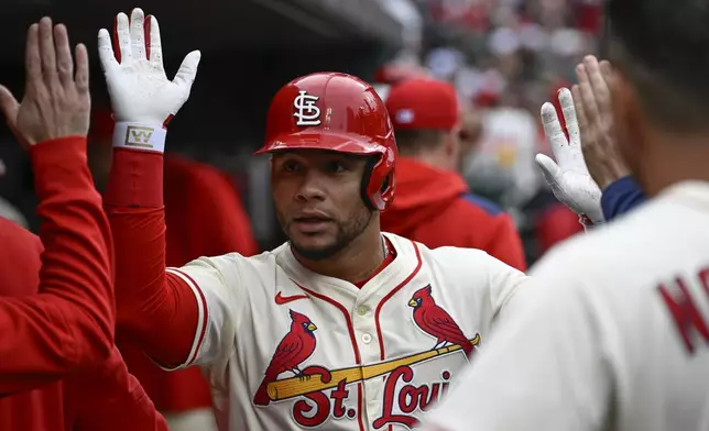 St. Louis Cardinals' Willson Contreras, center, is congratulated by teammates after hitting a solo home run in the second inning during the first baseball game of a doubleheader against the New York Mets, Sunday, May 4, 2025, in St. Louis. (AP Photo/Joe Puetz)