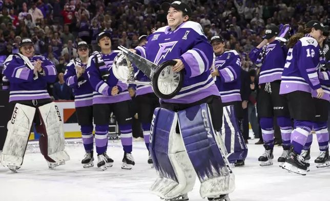 Minnesota Frost goaltender Maddie Rooney celebrates with the Walter Cup after her team won the PWHL hockey finals against the Ottawa Charge, Monday, May 26, 2025, in St. Paul, Minn. (AP Photo/Ellen Schmidt)