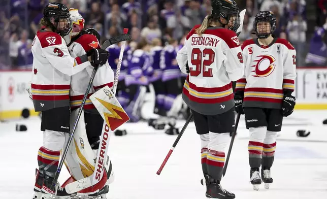 Ottawa Charge players react after losing Game 4 of the PWHL hockey finals in overtime to the Minnesota Frost Monday, May 26, 2025, in St. Paul, Minn. (AP Photo/Ellen Schmidt)