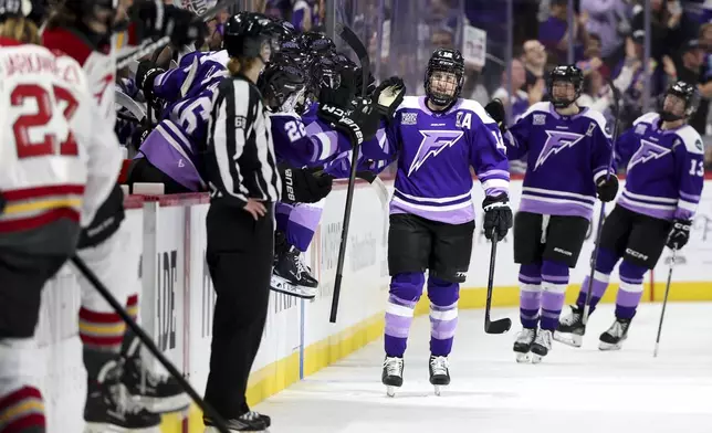 Minnesota Frost forward Kelly Pannek, center, celebrates at the bench after scoring against the Ottawa Charge during the second period of Game 4 of the PWHL hockey finals Monday, May 26, 2025, in St. Paul, Minn. (AP Photo/Ellen Schmidt)