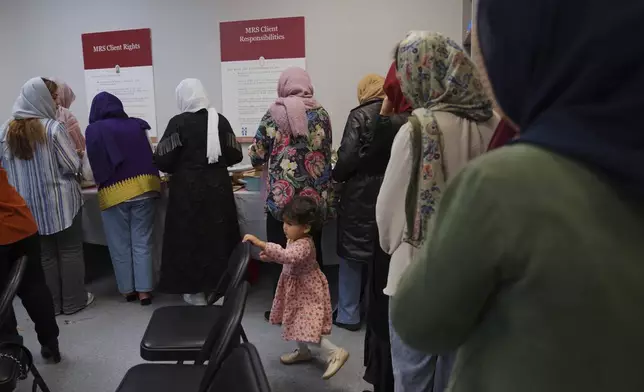 A group of female Afghan refugees gather for a class on self-care and a post-Ramadan celebration at Catholic Charities Migrant and Refugee Services office in Fredericksburg, Va., on Tuesday, April 8, 2025. (AP Photo/Jessie Wardarski)