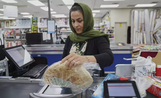 Locals shop at the Finest Supermarket halal grocery store in Fredericksburg, Va., on Monday, April 7, 2025. (AP Photo/Jessie Wardarski)
