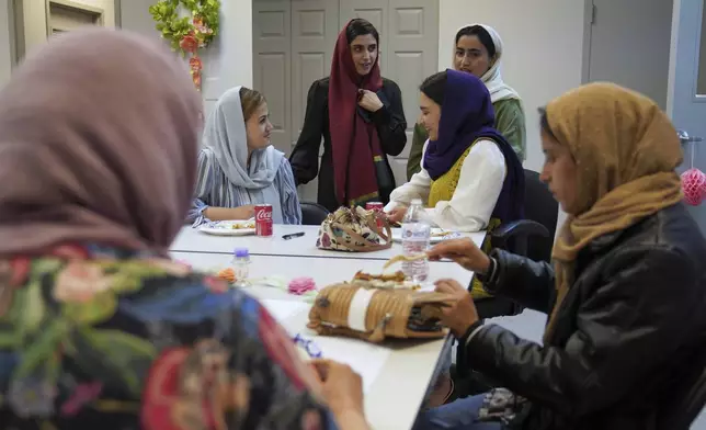 A group of female Afghan refugees gather for a class on self-care and a post-Ramadan celebration at Catholic Charities Migrant and Refugee Services office in Fredericksburg, Va., on Tuesday, April 8, 2025. (AP Photo/Jessie Wardarski)
