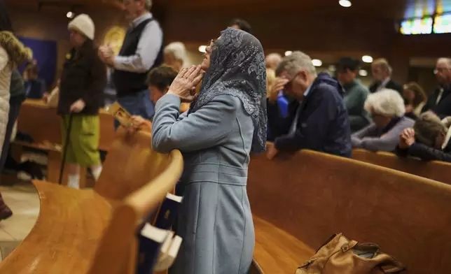 A parishioner prays during a morning Mass at St. Mary of the Immaculate Conception Catholic Church in Fredericksburg, Va., on Wednesday, April 9, 2025. (AP Photo/Jessie Wardarski)