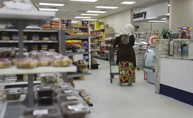 Locals shop at the Finest Supermarket halal grocery store in Fredericksburg, Va., on Monday, April 7, 2025. (AP Photo/Jessie Wardarski)