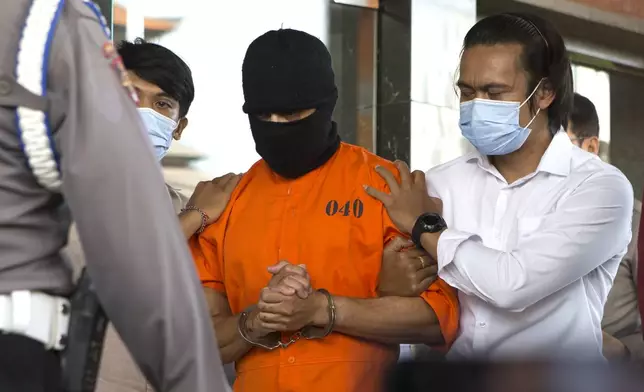 An Australian man arrested for allegedly smuggling cocaine is escorted to a news conference at the police headquarters in Bali, Indonesia, Monday, May 26, 2025. (AP Photo/Firdia Lisnawati)