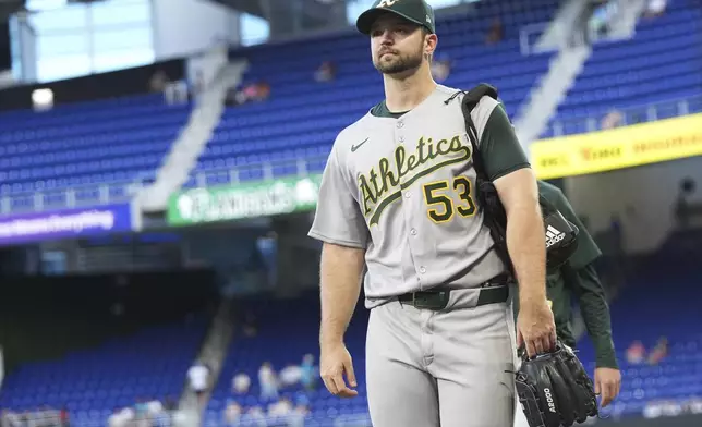Oakland Athletics starting pitcher Gunnar Hoglund (53) walks to the dugout before a baseball game against the Miami Marlins, Friday, May 2, 2025, in Miami. (AP Photo/Lynne Sladky)