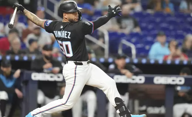 Miami Marlins' Agustín Ramírez (50) follows through on a double during the fourth inning of a baseball game against the Oakland Athletics, Friday, May 2, 2025, in Miami. (AP Photo/Lynne Sladky)