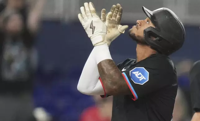 Miami Marlins' Dane Myers reacts as he crosses the plate after hitting a solo home run during the sixth inning of a baseball game against the Oakland Athletics, Friday, May 2, 2025, in Miami. (AP Photo/Lynne Sladky)
