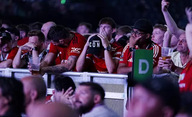 Manchester United fans react during a screening of the Europa League final soccer match between Manchester United and Tottenham Hotspur taking place in Bilbao, at the AO Arena, Manchester, England, Wednesday, May 21, 2025. (Peter Byrne/PA via AP)