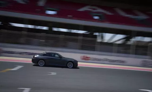A female driver is seen behind the wheel during the first all-women supercar rally in Dubai, United Arab Emirates, Thursday, May 1, 2025. (AP Photo/ Fatima Shbair)