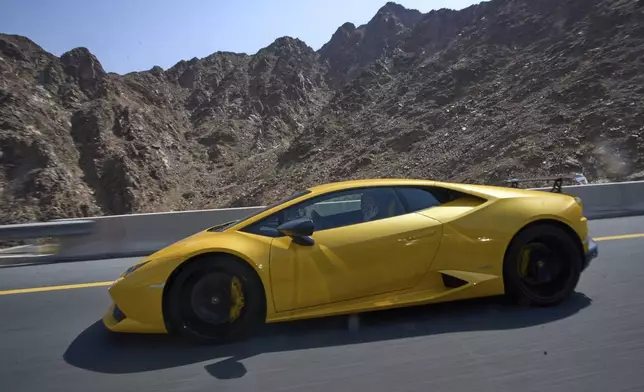 A female driver is seen behind the wheel during the first all-women supercar rally in Dubai, United Arab Emirates, Thursday, May 1, 2025. (AP Photo/ Fatima Shbair)