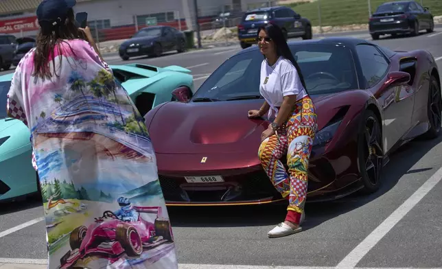 A participant poses for a photo during the first all-women supercar rally in Dubai, United Arab Emirates, Thursday, May 1, 2025. (AP Photo/ Fatima Shbair)