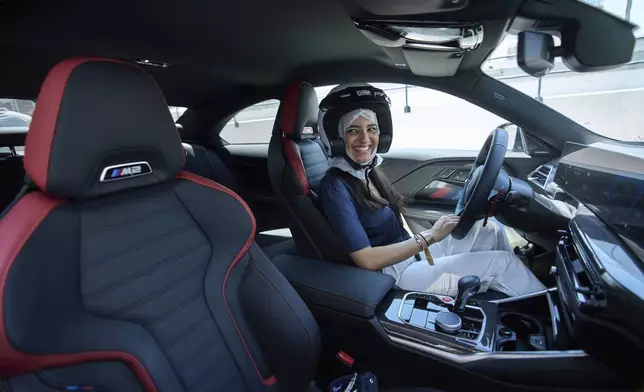 A female driver is seen behind the wheel during the first all-women supercar rally in Dubai, United Arab Emirates, Thursday, May 1, 2025. (AP Photo/ Fatima Shbair)