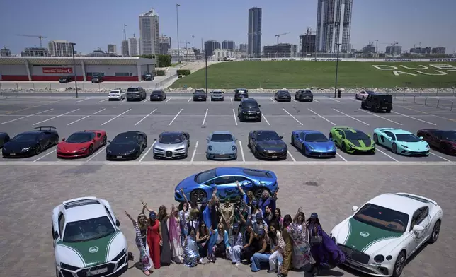 Participants pose for a photo during the first all-women supercar rally in Dubai, United Arab Emirates, Thursday, May 1, 2025. (AP Photo/ Fatima Shbair)