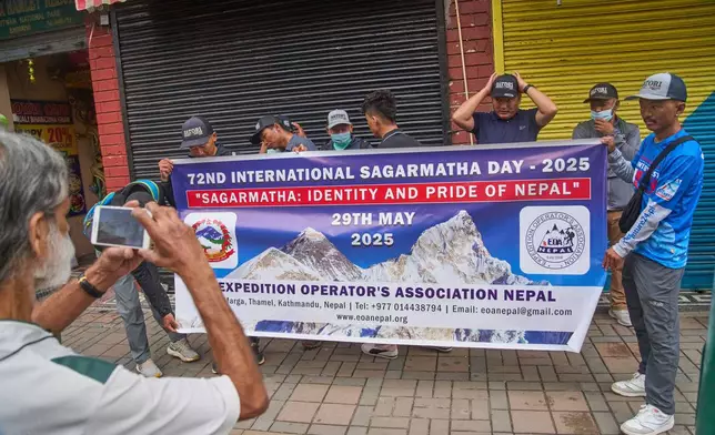 People from the mountaineering community gather to participate in a rally to mark the anniversary of the first ascent of Mount Everest in Kathmandu, Nepal, Thursday, May 29, 2025. (AP Photo/Niranjan Shrestha)