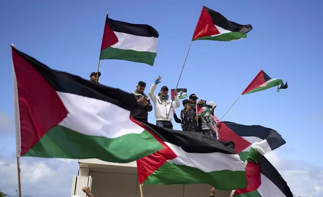 Moroccans protest the docking of a Maersk cargo ship carrying airplane parts they suspect are headed to Israel, outside Tangier Med Port, Sunday, April 20, 2025. (AP Photo/Mosa'ab Elshamy)