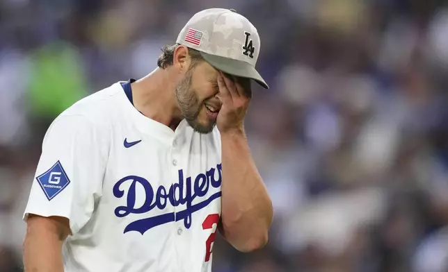 Los Angeles Dodgers starting pitcher Clayton Kershaw wipes his face after the top of the third inning of a baseball game against the Los Angeles Angels, Saturday, May 17, 2025, in Los Angeles. (AP Photo/Mark J. Terrill)