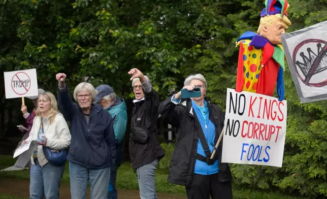 Demonstrators protest near Trump National Golf Club Washington DC before the arrival of President Donald Trump in Sterling, Va., Thursday, May 22, 2025. (AP Photo/Rod Lamkey, Jr.)