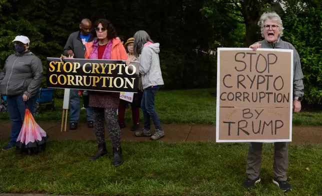 Demonstrators protest near Trump National Golf Club Washington DC before the arrival of President Donald Trump in Sterling, Va., Thursday, May 22, 2025. (AP Photo/Rod Lamkey, Jr.)