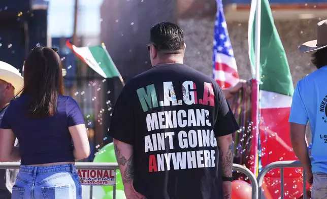 Vincent Ramirez's shirt expresses his thoughts as he watches a Cinco de Mayo parade in the Oak Cliff section of Dallas, Saturday, May 3, 2025. (AP Photo/LM Otero)