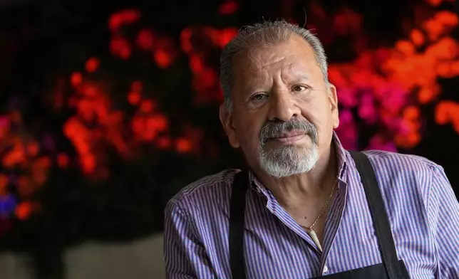 Michelin-starred Chef Mario Hernández Alonso of El Califa de León taqueria in Mexico City, stops for a photography while he prepares tacos at a Cinco de Mayo pop-up event at The Mexicano, Monday, May 5, 2025, in Phoenix. (AP Photo/Matt York)