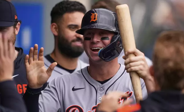 Detroit Tigers' Spencer Torkelson is congratulated by teammates in the dugout after scoring on a single by Trey Sweeney during the second inning of a baseball game against the Los Angeles Angels, Sunday, May 4, 2025, in Anaheim, Calif. (AP Photo/Mark J. Terrill)