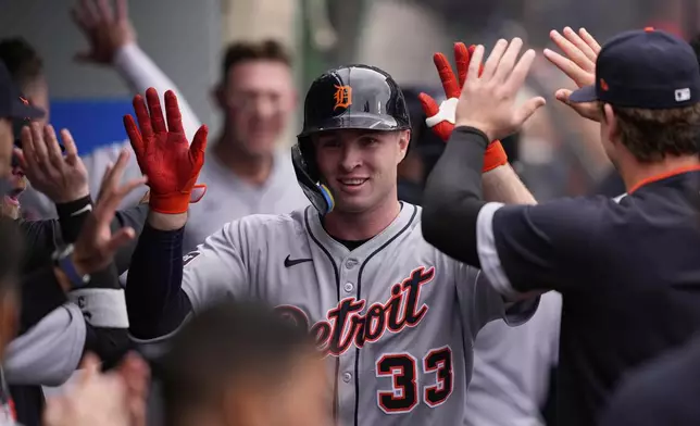 Detroit Tigers' Colt Keith is congratulated by teammates in the dugout after hitting a two-run home run during the third inning of a baseball game against the Los Angeles Angels, Sunday, May 4, 2025, in Anaheim, Calif. (AP Photo/Mark J. Terrill)