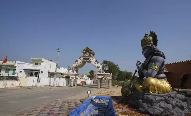 FILE - A statue of Monkey God Hanuman, installed as part of a religious celebrations, is seen in front of an entrance gate of Dingucha village in Gandhinagar, India, Tuesday, Nov. 12, 2024. (AP Photo/Ajit Solanki, File)