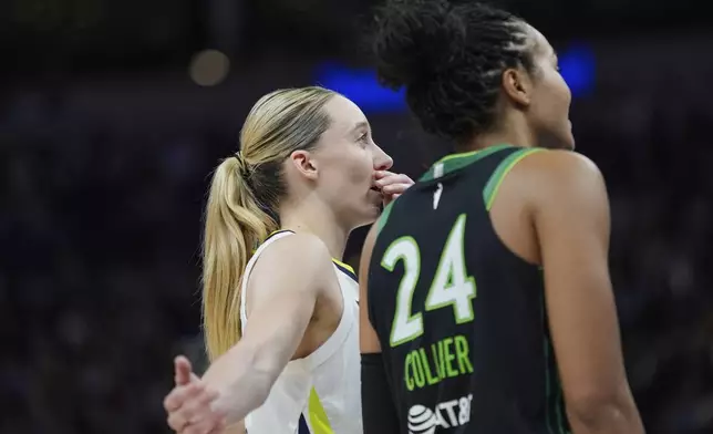 Dallas Wings guard Paige Bueckers (5) and Minnesota Lynx forward Napheesa Collier (24) talk during the second half of a WNBA basketball game Wednesday, May 21, 2025, in Minneapolis. (AP Photo/Abbie Parr)