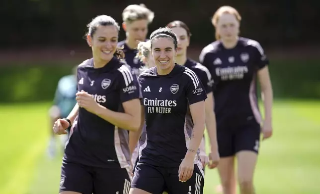 Arsenal's Mariona Caldentey, centre, smiles during a training session at the Sobha Realty Training Centre, London, Friday May 23, 2025, one day ahead of their final match of the Women's Champions League against FC Barcelona. (John Walton/PA via AP)