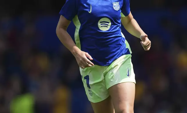 FILE - Barcelona's Alexia Putellas runs during warmup before the women's Champions League semifinals, second leg, soccer match against Chelsea FC at Stamford Bridge in London, April 27, 2025. (AP Photo/Dave Shopland, File)