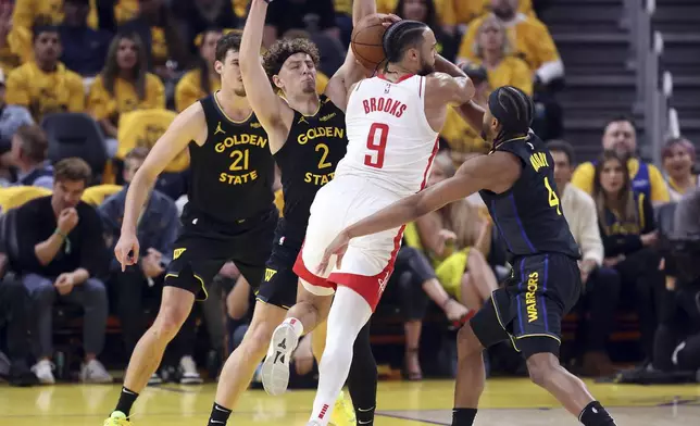 Golden State Warriors' Brandin Podziemskli (2) and Moses Moody (4) defend against Houston Rockets' Dillon Brooks (9) in the first quarter of Game 6 of an NBA basketball first-round playoff series Friday, May 2, 2025, in San Francisco. (Scott Strazzante/San Francisco Chronicle via AP)