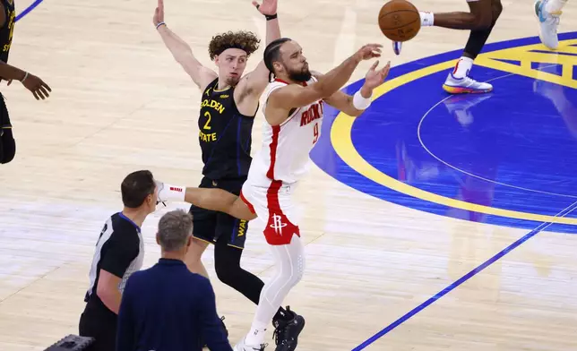 Houston Rockets forward Dillon Brooks (9) passes the ball while guarded by Golden State Warriors guard Brandin Podziemski (2) in the second quarter of Game 6 of an NBA basketball first-round playoff series Friday, May 2, 2025, in San Francisco. (Santiago Mejia/San Francisco Chronicle via AP)
