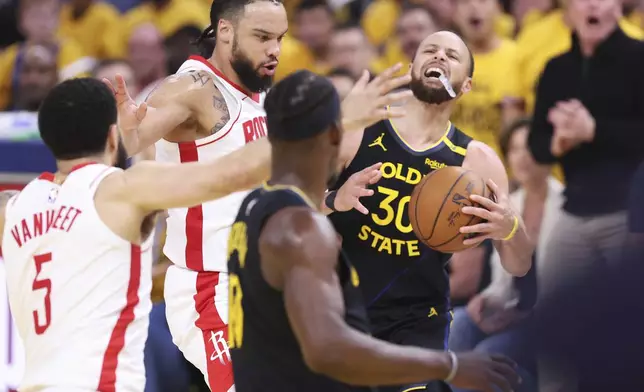 Golden State Warriors' Stephen Curry (30) is fouled by Houston Rockets' Dillon Brooks, top left, before making a basket in the second quarter of Game 6 of an NBA basketball first-round playoff series Friday, May 2, 2025, in San Francisco. (Scott Strazzante/San Francisco Chronicle via AP)