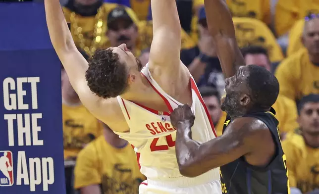 Golden State Warriors' Draymond Green, right, cannot stop Houston Rockets' Alperen Sengun, left, from scoring in the first quarter of Game 6 of an NBA basketball first-round playoff series Friday, May 2, 2025, in San Francisco. (Scott Strazzante/San Francisco Chronicle via AP)