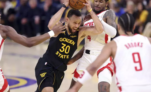 Golden State Warriors' Stephen Curry (30) drives against Houston Rockets' Jalen Green (4) in the second quarter of Game 6 of an NBA basketball first-round playoff series Friday, May 2, 2025, in San Francisco. (Scott Strazzante/San Francisco Chronicle via AP)