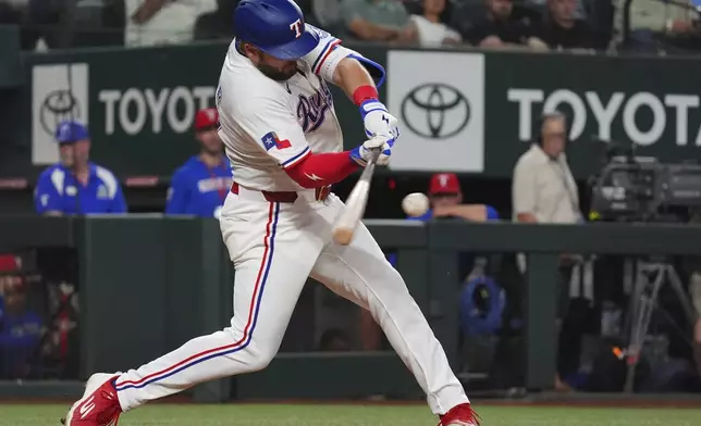 Texas Rangers Jake Burger hits a home run during the sixth inning of a baseball game against the Houston Astros, Thursday, May 15, 2025, in Arlington, Texas. (AP Photo/LM Otero)