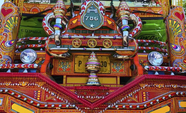 Decorated metal pieces are mounted on the front of a newly refurbished truck at a yard for workshops in Rawalpindi, Pakistan, Thursday, April 24, 2025. (AP Photo/Anjum Naveed)