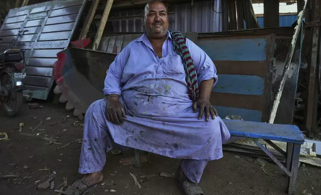Artisan Muhammad Ashfaq, 55, sits for a portrait at his workshop in Rawalpindi, Pakistan, on Sunday, April 27, 2025. (AP Photo/Anjum Naveed)