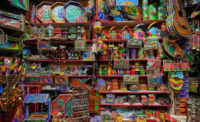 Various household decorative items painted in truck art patterns are displayed for sale at a shop in Islamabad, Pakistan, Tuesday, April 22, 2025. (AP Photo/Anjum Naveed)